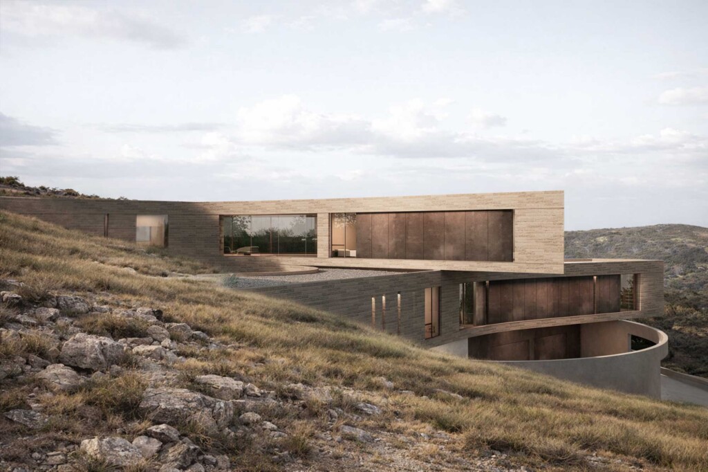 Modern hillside residence with stacked stone volumes, large windows, and curved driveway on rocky