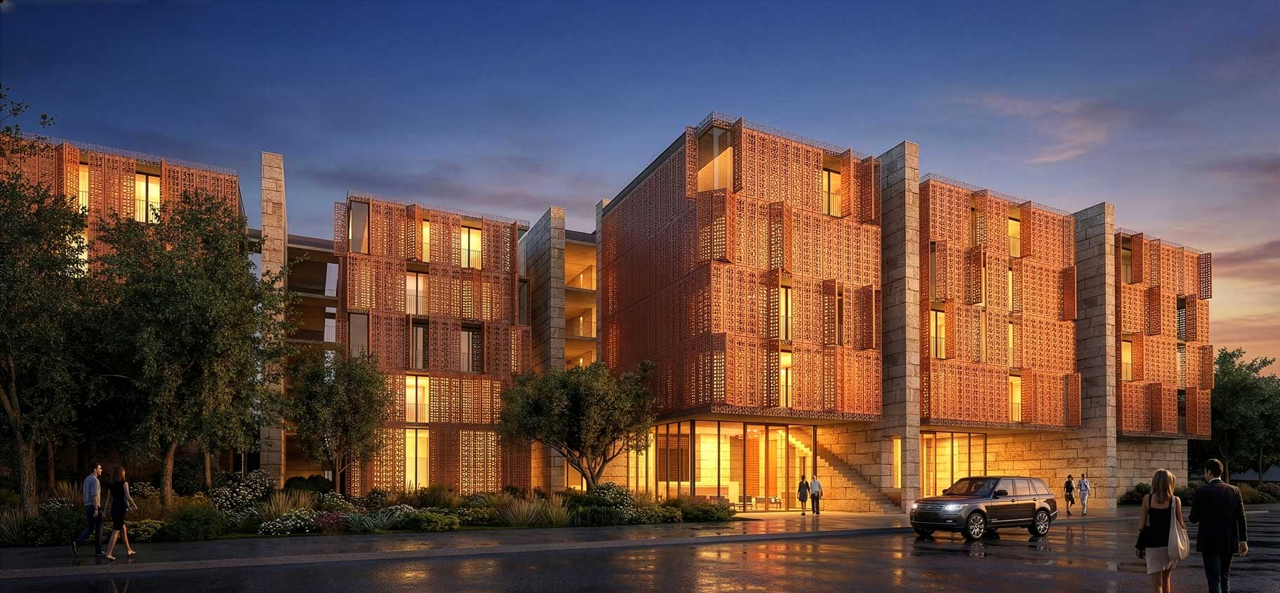 Modern hotel with decorative terracotta screens stone accents and warm interior lighting at dusk