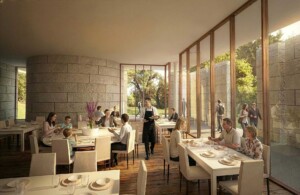 Modern hotel restaurant with stone walls floor-to-ceiling windows diners at white tables and server