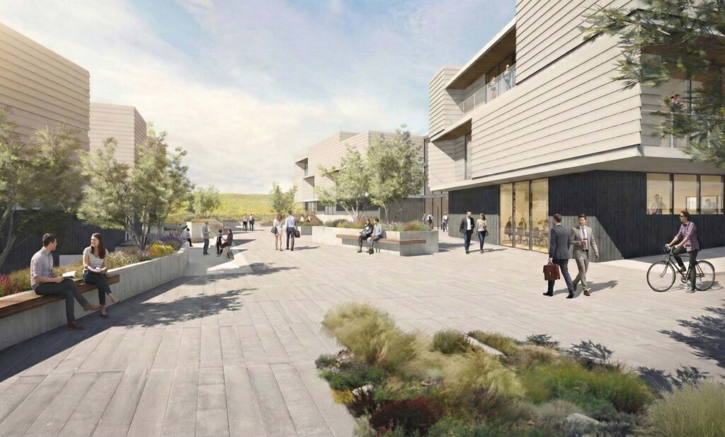 Modern office complex courtyard with terraced buildings, outdoor seating, landscaping and people