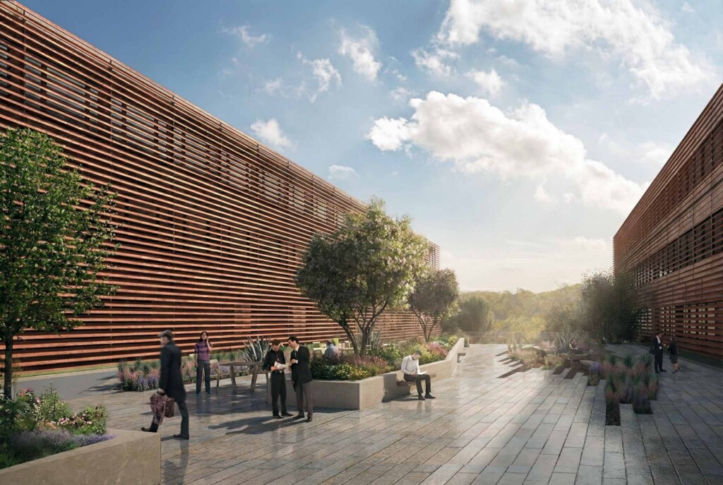 Outdoor terrace with wooden slatted building facades, landscaped planters, and people walking