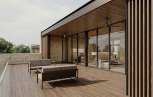 Austin TX luxury home patio with wood deck, stone walls, floor-to-ceiling glass and modern outdoor seating area